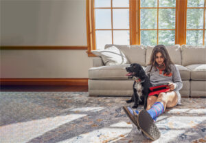 student learning at home with her dog